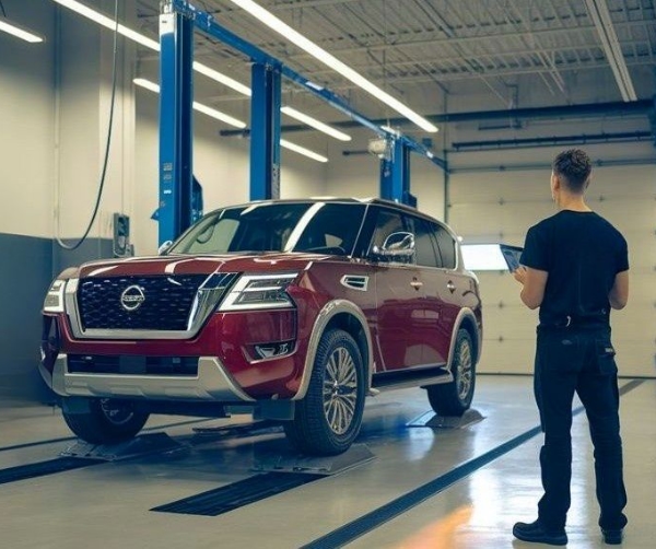 Nissan Certified Collision Repair red pathfinder in shop